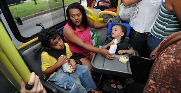 Já no coletivo, ela alimenta os filhos depois de um dia de terapias